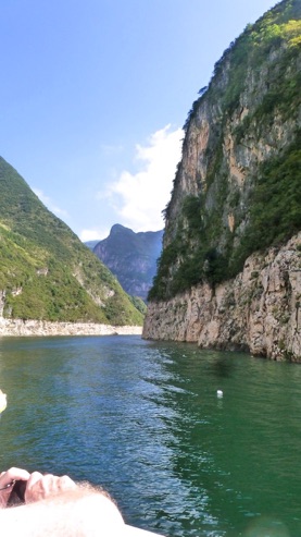 In the Three Little Gorges on the Daning River, a tributary of the Yangtze. A sightseeing boat is in the foreground. The clear blue skies are unusual for China